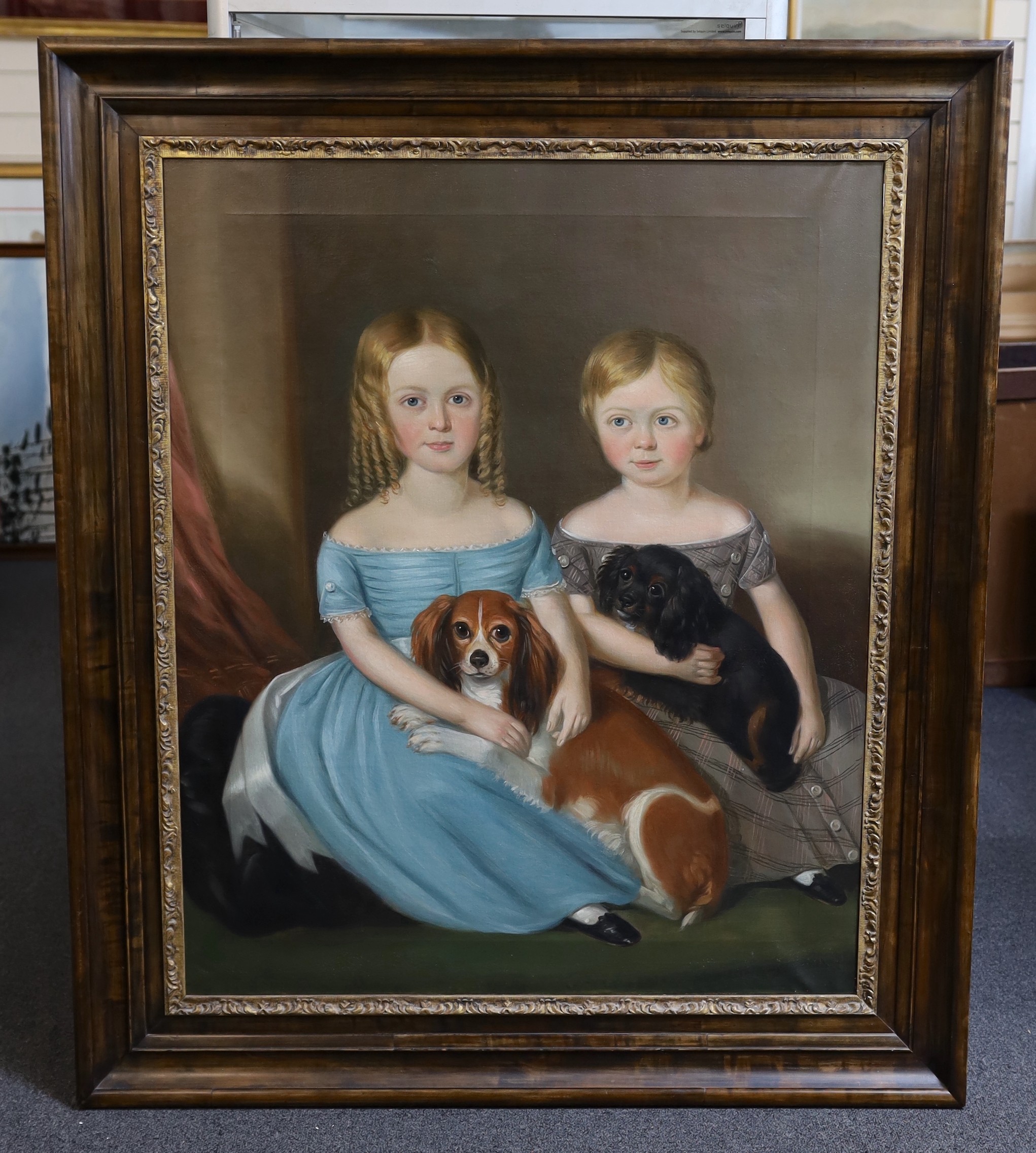 Mid 19th century English School, Portrait of two children seated with their King Charles Spaniels, oil on canvas, 91 x 74cm